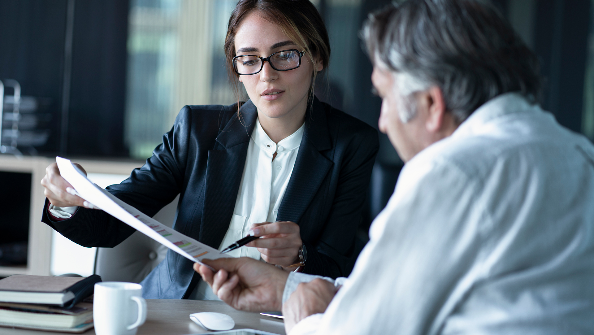 Woman executive explaining a report to a colleague