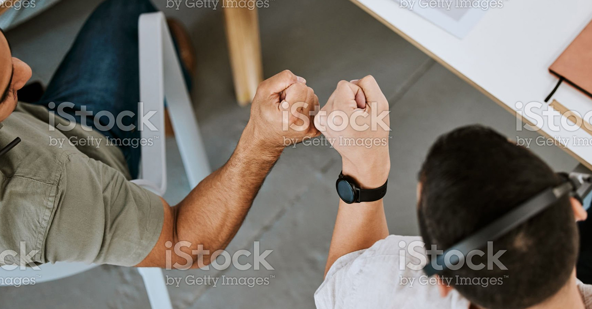 Two colleagues bumping fists